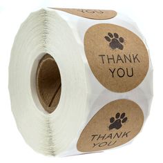 a roll of toilet paper with thank you stickers on the side and paw prints