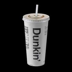 a drink with a straw in it sitting on a black background, that says dunkin'donuts