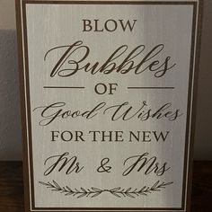 a wooden sign that says blow bubbles of good wishes for the new mr and mrs