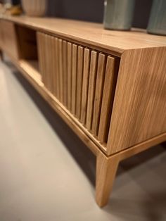 a close up of a wooden shelf with glass on it's top and bottom