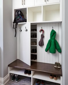 an image of a room with shoes and coat racks on the wall in front of it