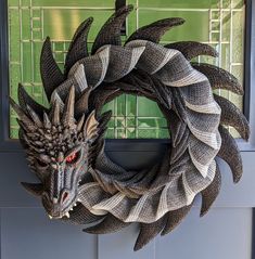 a door wreath with a dragon head on it