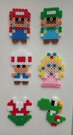 four pieces of lego art made to look like mario and luigi's character heads