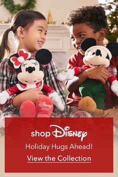 two children holding stuffed animals in front of a christmas tree with the words shop disney holiday hugs ahead view the collection