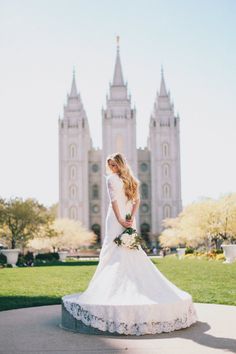 a bride standing in front of a large building