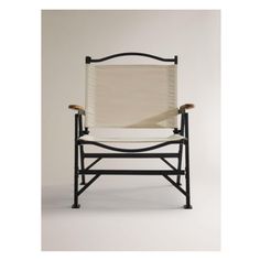 a black and white chair with a tan seat cover on it's backrest