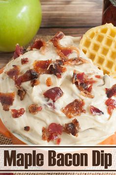 a plate topped with bacon dip and waffles next to an apple