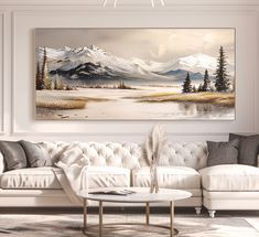 a living room with a white couch and painting on the wall above it's coffee table