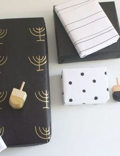 black and white wrapping paper with gold foiling on it, next to other items