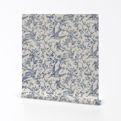 a blue and white wallpaper with birds on it