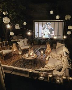 a living room filled with lots of furniture and lights on top of a wooden floor