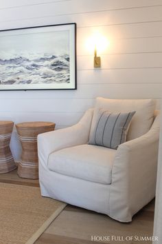 a living room with white walls and wood floors