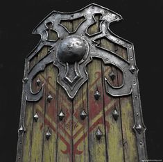 an old wooden door with metal decorations on it