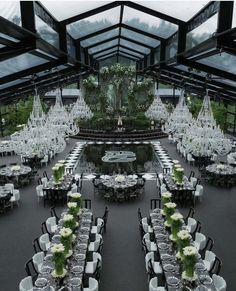 an indoor dining area with tables, chairs and chandeliers set up for a formal function