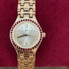 Vintage Jaz Paris French Designer Gold 18k Gold Plated Watch With Red Cubic Zirconia Cz Bezel 7.25 Inch Long Link Bracelet Stainless Steel Back Jz0062 Very Good Working Order, Champagne Dial Arabic Numerals, Gold Hands And Hour Markers. The Crystal Is Mineral Glass. The 15/16 Inch Diameter Watch Case Is Gold Plated. Assembled In France With A High Quality Japanese Movement. 7.25 Inch In Length And 1/2 Inch Wide . Clean Mineral Crystal See Pictures Case Marked 1990's New Battery Sanitized Serviced Gold Plated Watch, French Designer, Gold Hands, Watch Case, Minerals Crystals, French Design, Gold Design, Vintage Accessories, Stainless Steel Bracelet