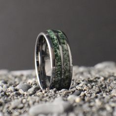 This ring is for those that want a nice and simple Moss Agate Band! We use real crushed up moss agate that is inlayed in a durable tungsten core. The tungsten is extremely scratch resistant and if it cracks within the first year, we will replace the ring!  Moss Agate makes a great stone for a ring because of its wide variety of green, clear and white colors. Each ring is different and would make the perfect wedding band, promise ring, anniversary ring, or just a great gift! **PLEASE READ** : Moss agate is a natural stone that contains clear, white, and green colors. The ring might have more white or greener and we can't guarantee it will look exactly like the photos. Please reach out and let us know what you would like, and we will do our best to accommodate.  To purchase our ring engravin Moss Agate Engagement Ring Men, Moss Agate Ring For Men, Mens Moss Agate Wedding Band, Men’s Wedding Rings Moss Agate, Nature-inspired Moss Agate Jewelry With Natural Inclusions, Moss Agate Ring, Agate Ring, Moss Agate, Promise Rings