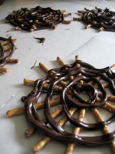 chocolate sticks are arranged in the shape of an intricate design on top of a table