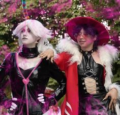 two women dressed in costumes standing next to each other