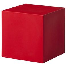 a red cube sitting on top of a white floor