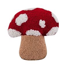 a red and white mushroom hat on top of a wooden base