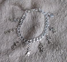 If you are checking out my feedback and see that I have sold something that you would like please just drop me a line.  I can almost certainly make you another one. Thanks. THIS ITEM Really sweet silver coloured charm bracelet made from metal (NOT sterling silver). The chain is lightweight aluminium and the charms are plated to look like silver. 7 charms in the shape of a teddy bear holding a flower and 1 heart-shaped charm which says 'made with love'. Large lobster claw clasp for security. Each Handmade Silver Charm Bracelet For Birthday Gift, Personalized Silver Charm Bracelet For Gift Making, Silver Charm Bracelet With Lobster Clasp For Personalized Gift, Silver Charm Bracelet For Best Friend Gift, Silver Charm Bracelet For Best Friend, Handmade Silver Charm Bracelet For Mother's Day, Silver Bracelet Jewelry For Gift Making, Charmed Show, Cute Teddy Bear