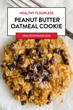 an oatmeal cookie with chocolate chips and coconut flakes on top, in front of a fork