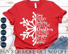 a red t - shirt with white snowflake on it and the words merry christmas written