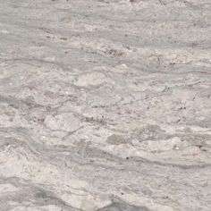 a white marble counter top with brown and gray veining on it's edges