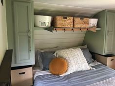 there is a bed with two baskets on the headboard