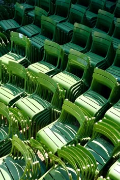 rows of green plastic chairs sitting next to each other