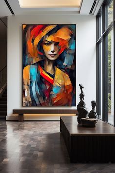 a large painting on the wall in a living room next to a vase and sculpture