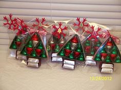 small christmas trees in clear bags with red and green decorations