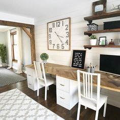 a living room filled with furniture and a large clock on the wall over a desk