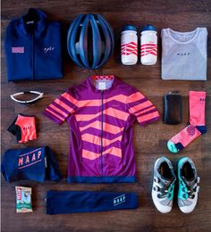 various items are laid out on a wooden floor to be used as a cycling outfit