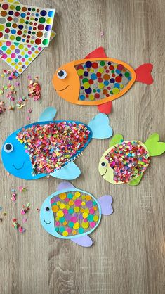 colorful paper fish and confetti on wooden table