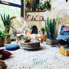 a living room filled with lots of plants and furniture