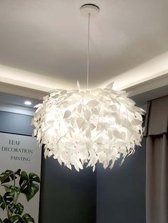 a large white chandelier hanging from the ceiling in a room with dark walls