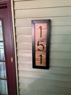 a house number sign mounted to the side of a building