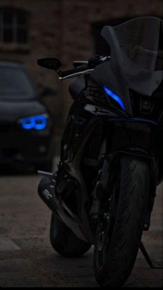 a black motorcycle parked next to a car