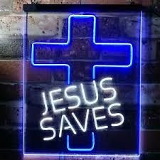 a neon sign that says jesus saves with a blue cross on the side of it