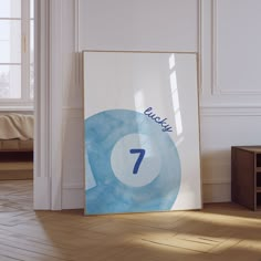 a blue and white poster with the number seven on it next to a coffee table