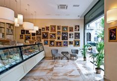 the interior of a restaurant with pictures on the wall