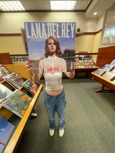 a woman holding up a sign in a library