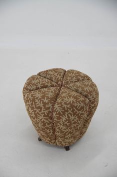 a foot stool made out of fabric with an interesting pattern on it's surface