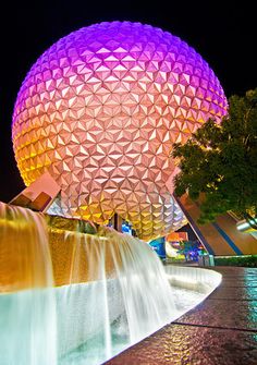 an instagram page with a photo of the spaceship at disney world in purple and yellow