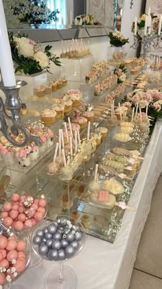 a table filled with lots of cupcakes and desserts on top of it