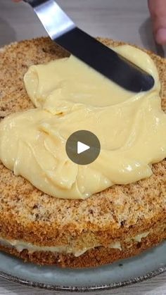 someone is spreading butter on top of a cake