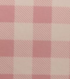 a pink and white checkered table cloth with a small red object on it's side