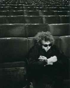 black and white photograph of a person sitting in an auditorium