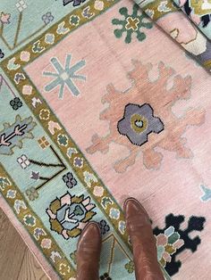 a person standing on the floor next to a rug